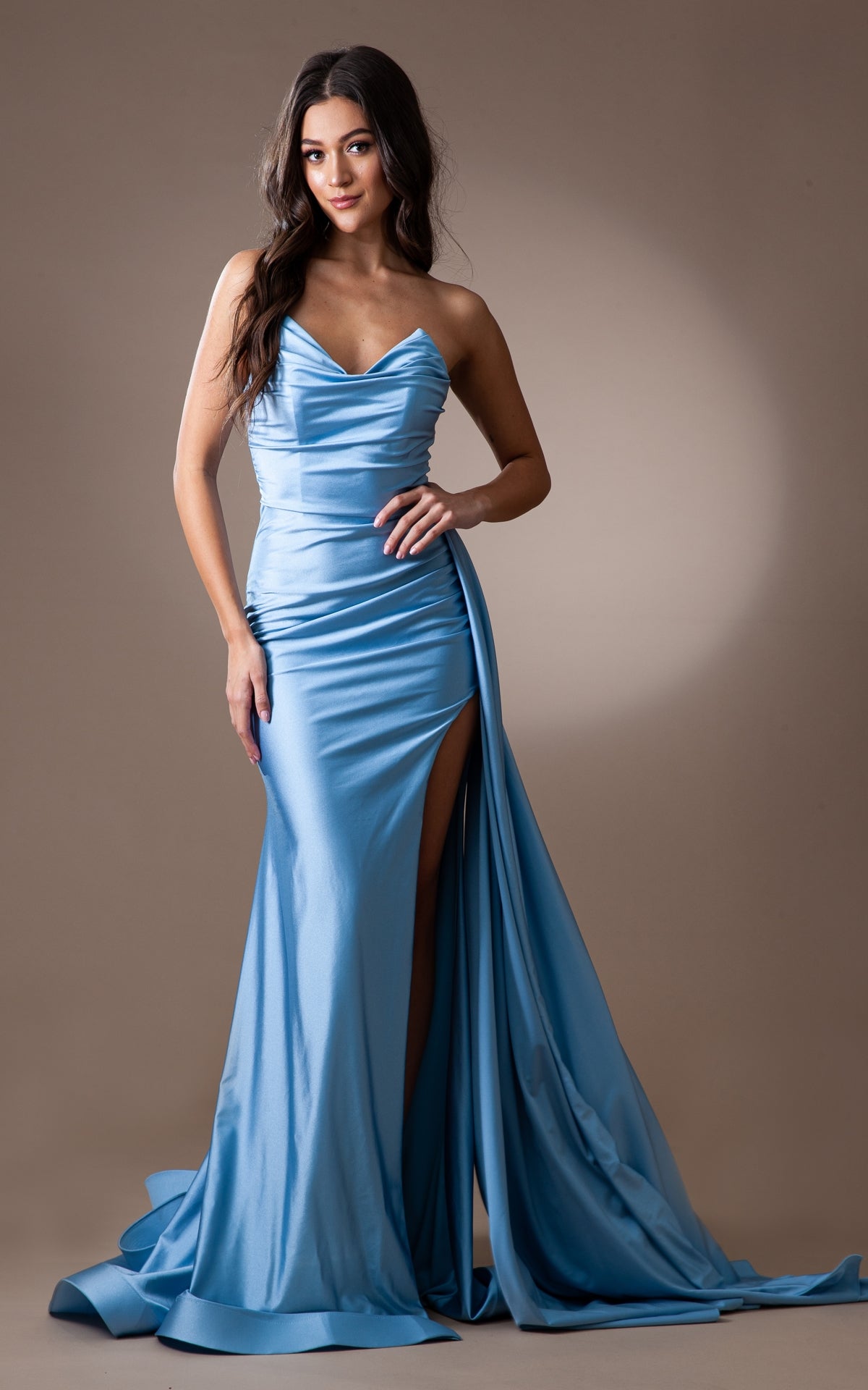 A woman models the Strapless Long Formal Prom Dress with Drape 3013—a light blue satin gown with a sweetheart neckline and high slit, perfect for special occasions—shown against a plain background.